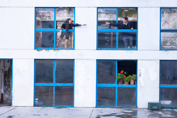 Friends trying to hold hands at old building