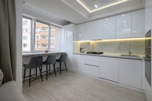 istock Interior of a modern white kitchen in a luxury studio apartmen 1428797023