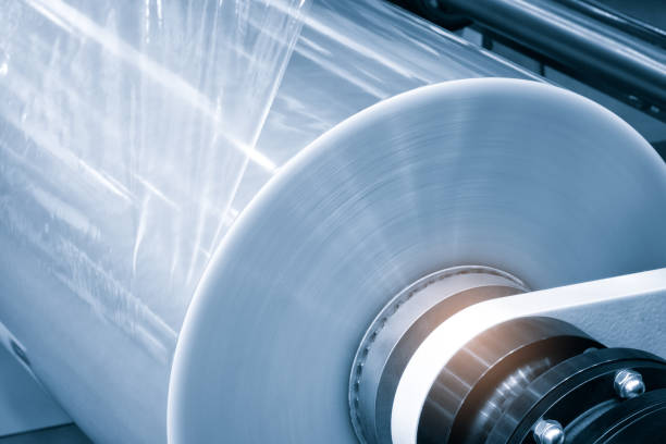 istock Automatic polyethylene plastic bag production machine with lighting effect. Close-up of the roller of the plastic bag production machine in the light blue scene. product packaging concept 1428797228