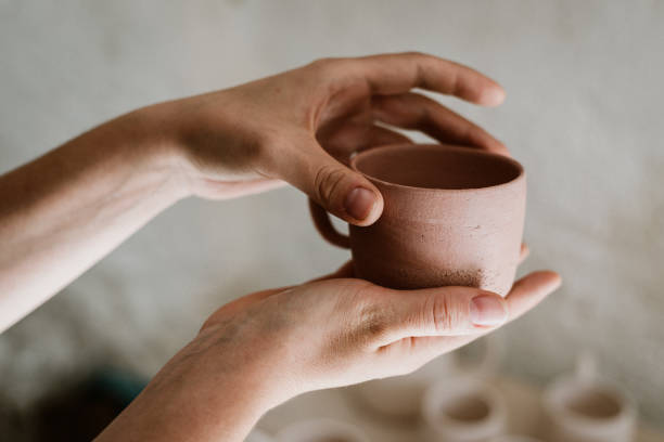 Woman examing her clay pots