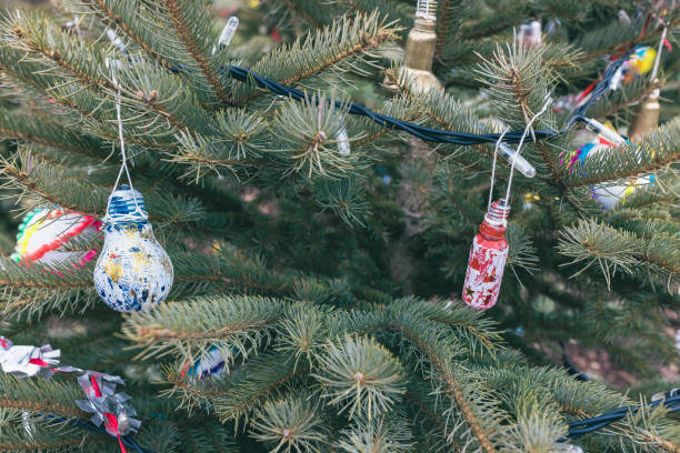 istock Painted red and blue old electric light bulb on Christmas tree. DIY decoration 1428798922