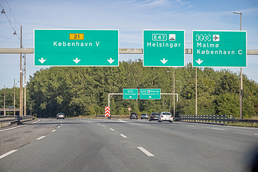 Blank road sign on onroad towards a highway. Add your own text