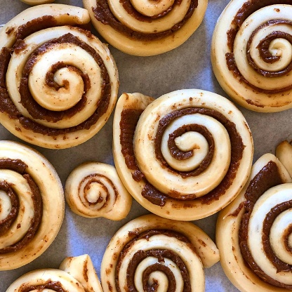 Cinnamon Rolls: Freshly Baked with Spices and Cocoa Filling Top View. He was hi raised in Sweden. and it's called Kanelbulle.