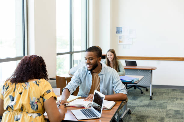 istock Young man and girlfriend work together in school library 1428801932