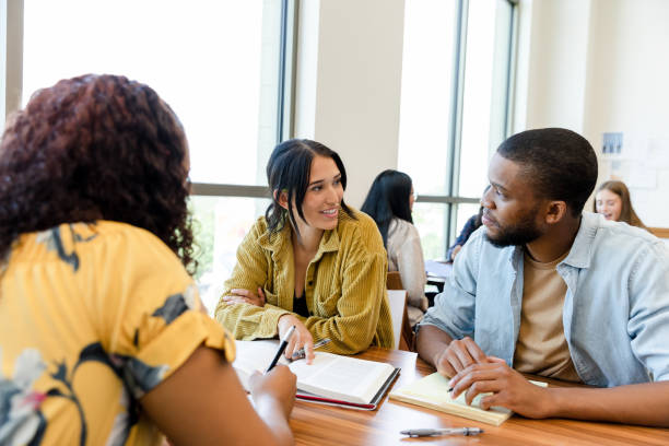istock Young woman discusses textbook information with boyfriend 1428801954