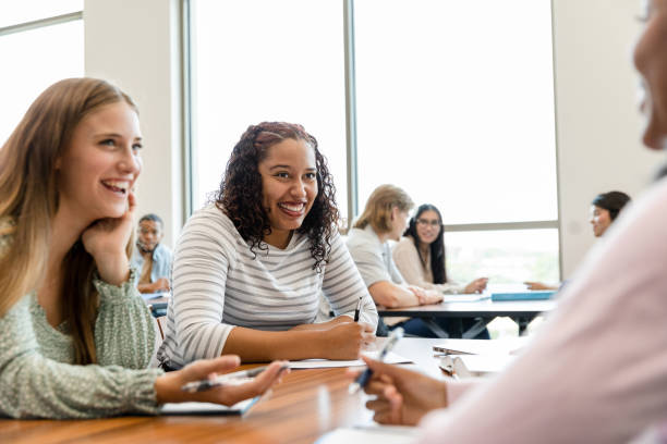istock Teen girls gossip and laugh while working on assignment 1428801958