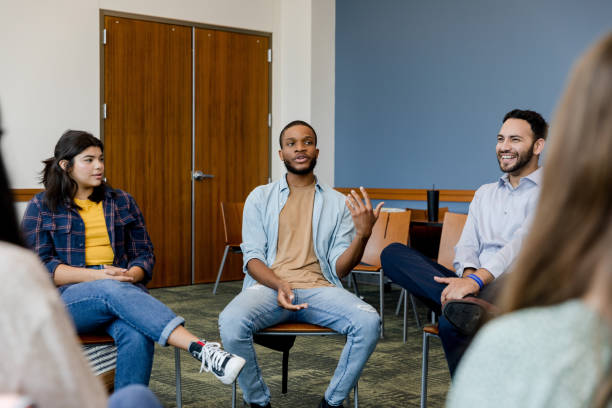 istock In group therapy, young man shares joke and counselor laughs 1428802003