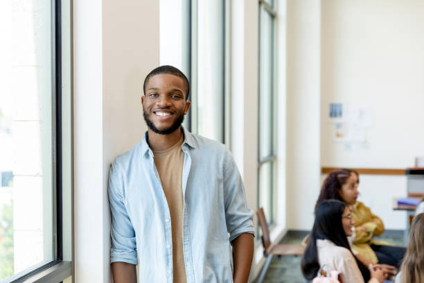 istock Casually dressed young adult teacher smiles for camera 1428802009