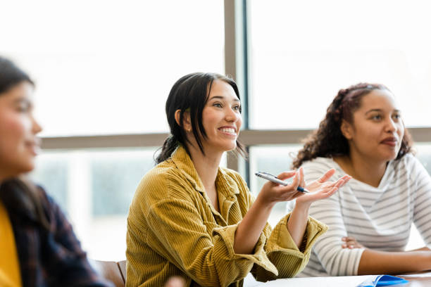 istock Young adult female university student asks unseen professor question 1428802049