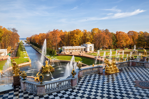 St. Petersburg, Russia - June 19, 2018: View of the Peterhof Grand Palace building exterior and fountain at sunny day, St. Petersburg, Russia. This is the famous tourist attraction in St. Petersburg, Russia.