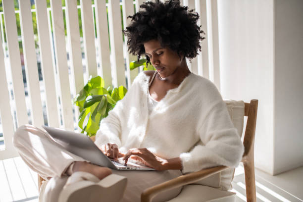 istock Concentrated woman typing on laptop while working from home 1428804952