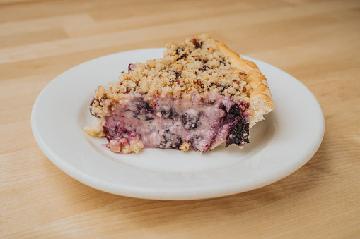 Pie with blueberry and sour cream with a pecan crumble