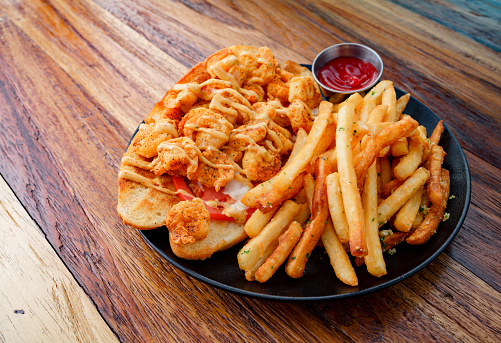 Shrimp po-boy sandwich with fries