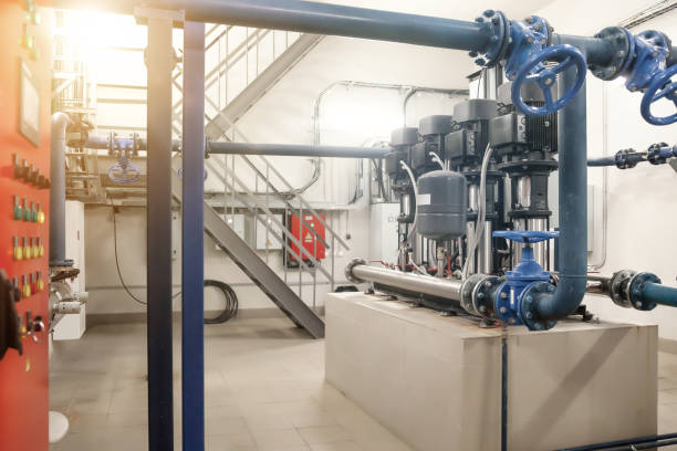 Industrial interior of water pump, valves, pressure gauges, motors inside engine room Industrial pumps in an engine room. Industry interior of water pump, valves, pressure gauges, motors inside technical room. Automatic control systems. Urban modern powerful pipelines. Copy text space technical routine stock pictures, royalty-free photos & images