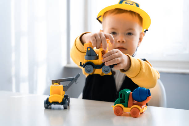 istock Child play with construction machinery at home, dreams to be an engineer. Little builder. Education, and imagination, purposefulness concept. Boy with digger 1428812422