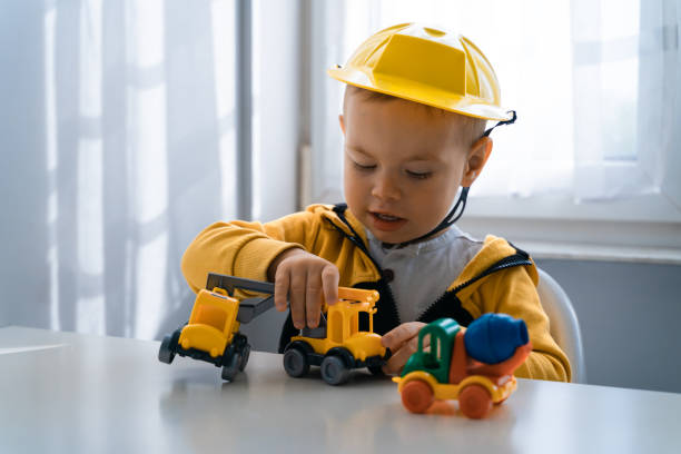 istock Child play with construction machinery at home, dreams to be an engineer. Little builder. Education, and imagination, purposefulness concept. Boy with digger 1428812423