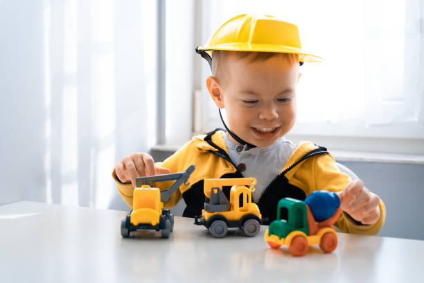 istock Child play with construction machinery at home, dreams to be an engineer. Little builder. Education, and imagination, purposefulness concept. Boy with digger 1428812424