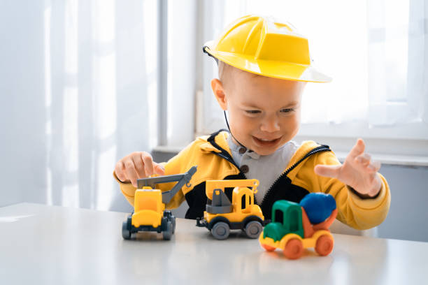 istock Child play with construction machinery at home, dreams to be an engineer. Little builder. Education, and imagination, purposefulness concept. Boy with digger 1428812425