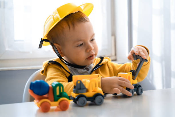 istock Child play with construction machinery at home, dreams to be an engineer. Little builder. Education, and imagination, purposefulness concept. Boy with digger 1428812434