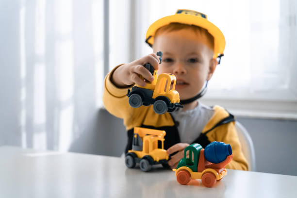 istock Child play with construction machinery at home, dreams to be an engineer. Little builder. Education, and imagination, purposefulness concept. Boy with digger 1428812437
