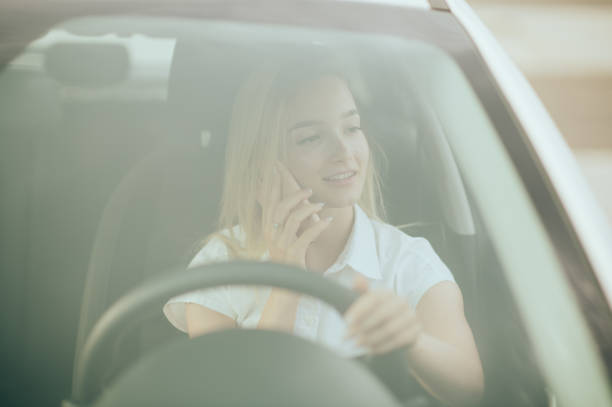 istock Young woman using phone in the car 1428813661