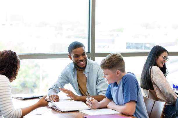 istock Male university tutor helps high school boy with homework 1428813725