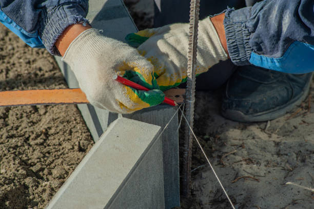 istock A worker measures a concrete block with a ruler, close-up. 1428813954