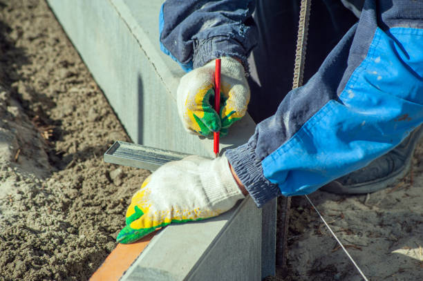 istock A worker measures a concrete block with a ruler, close-up. 1428814081