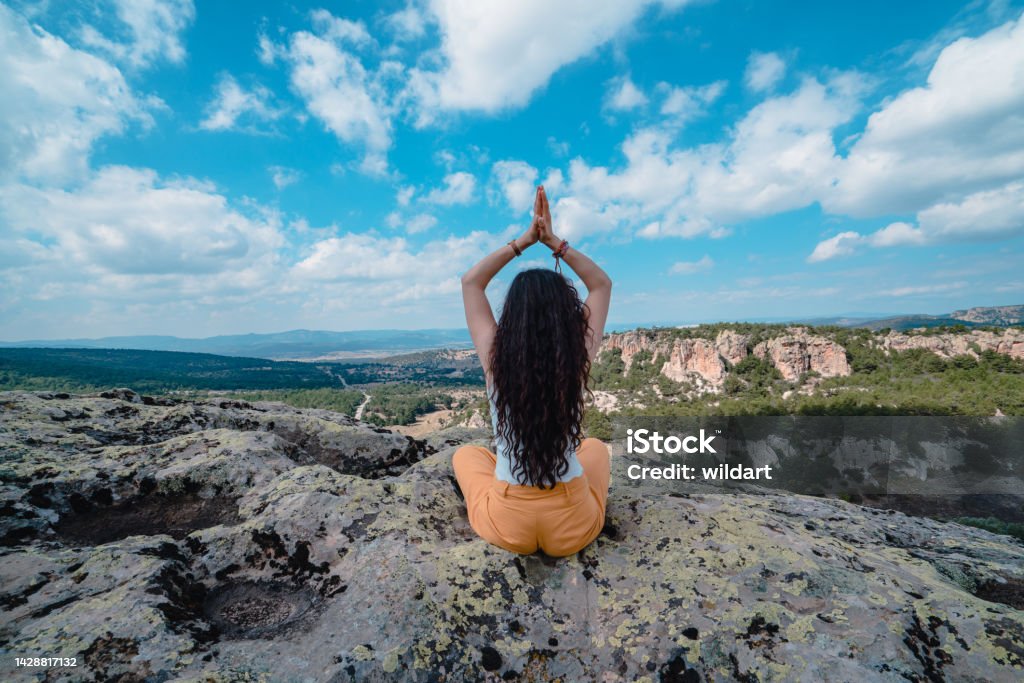 Beautiful woman is meditating, doing yoga in ancient ruins of  smll Midas city in the Phrygian valley in Phrygia ,Turkey frig valley, frigler, frigya, Phrygians,  Phrygia, frig vadisi 30-34 Years Stock Photo