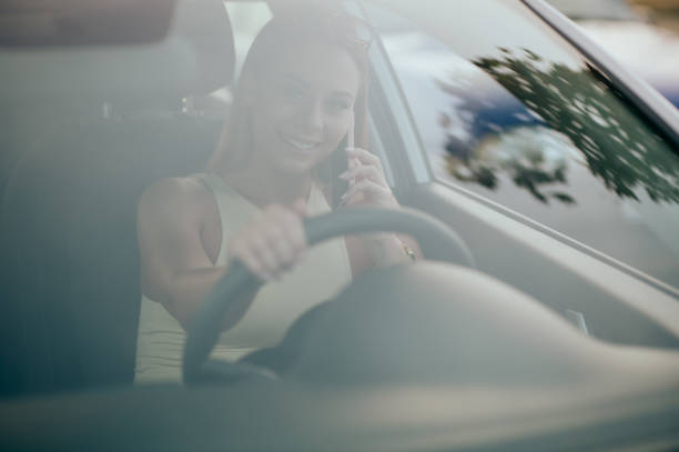 istock Young woman using phone in the car 1428820748