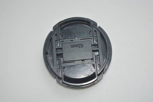 istock a black camera lens cap on a white background 1428823117
