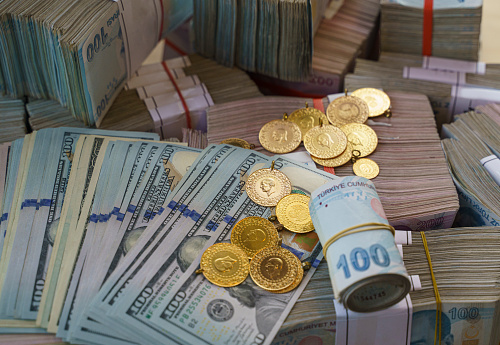 Large group of Turkish Lira banknotes with gold coins