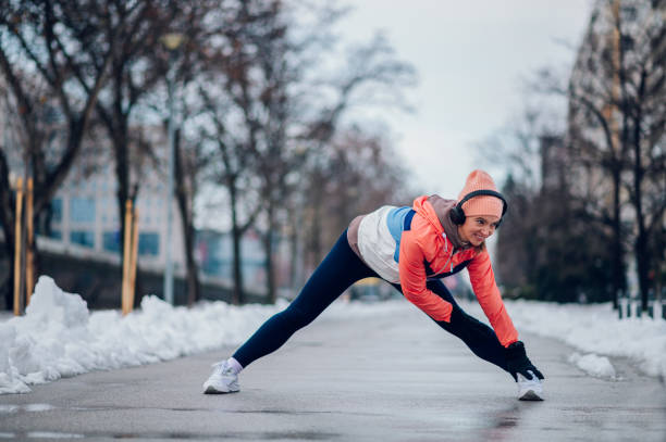 istock Woman does stretching before training in the snow in the winter. 1428825224