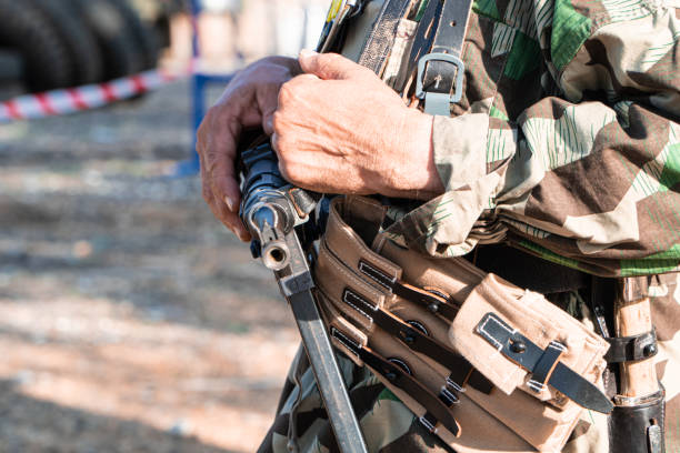 istock soldier with rifle walking on a restricted area 1428826735