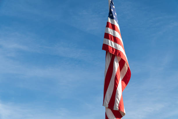 istock United states flag on blue sky with copy space 1428826742