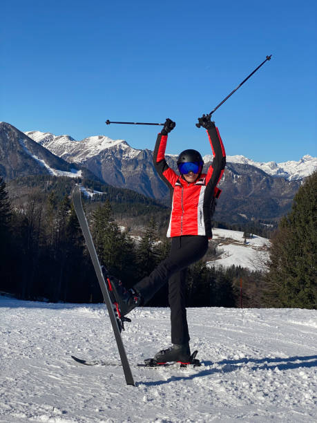 istock Playful Woman with ski on a slope 1428827965