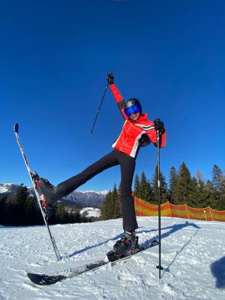 Playful Woman with ski on a slope