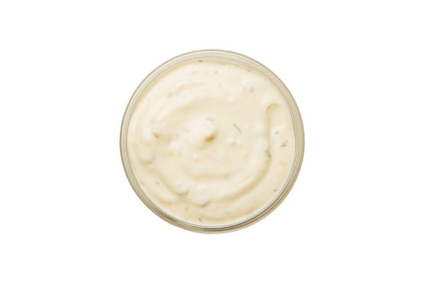 istock Bowl of Caesar sauce isolated on white background. top view 1428834923