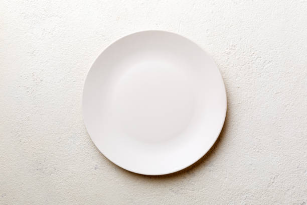 istock Top view of empty light plate on cement background. Empty space for your design 1428835015