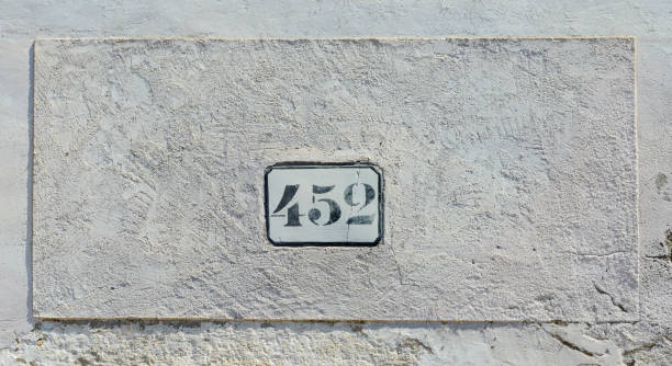 istock House number 452 sign to old white wall 1428845503
