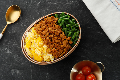 Three Color Japanese Rice Lunchbox with Stir Fry Minced Chicken, Boiled French Beans, and Scramble Eggs. Sanshoku Lunch Box