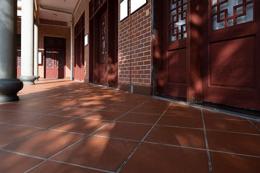 The Light Effect of Chinese Red Wooden Door and Red Brick Floor