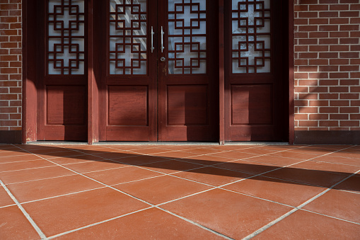 The Light Effect of Chinese Red Wooden Door and Red Brick Floor
