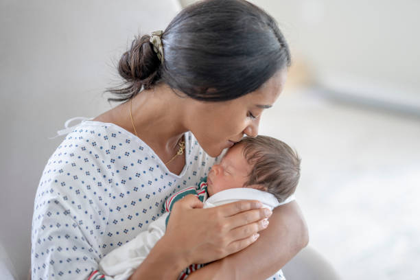 istock Mother Kissing Her Newborns Head 1428852174