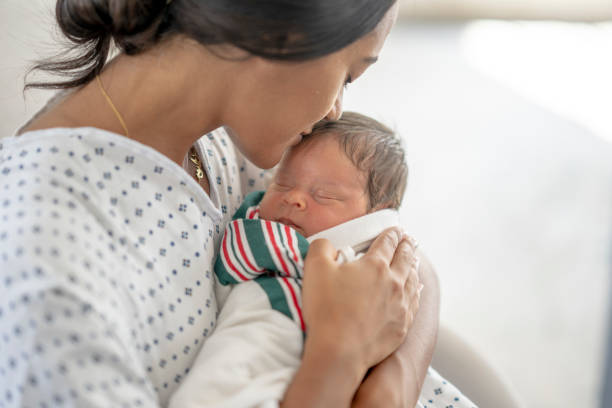 istock Mother Kissing Her Newborns Head 1428852196