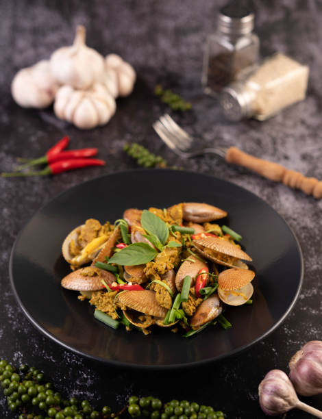 istock Clams fried curry powder on a black plate. 1428869641