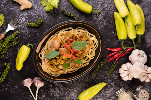 istock Spaghetti with Clams in a Black Plate with Chilies Fresh garlic and pepper. 1428869867