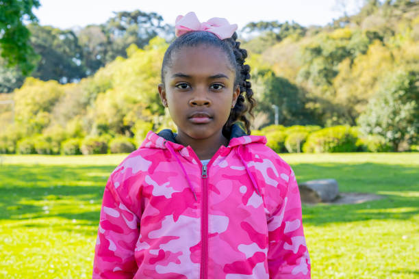 An Adorable african little girl with beautiful hairstyle isolated over white