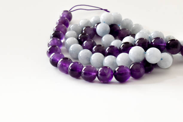 istock Amethyst and aquamarine bead strands on the table. 1428900926