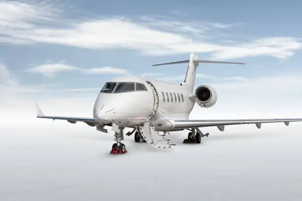 Close-up modern white private jet with an opened gangway door isolated on bright background with sky
